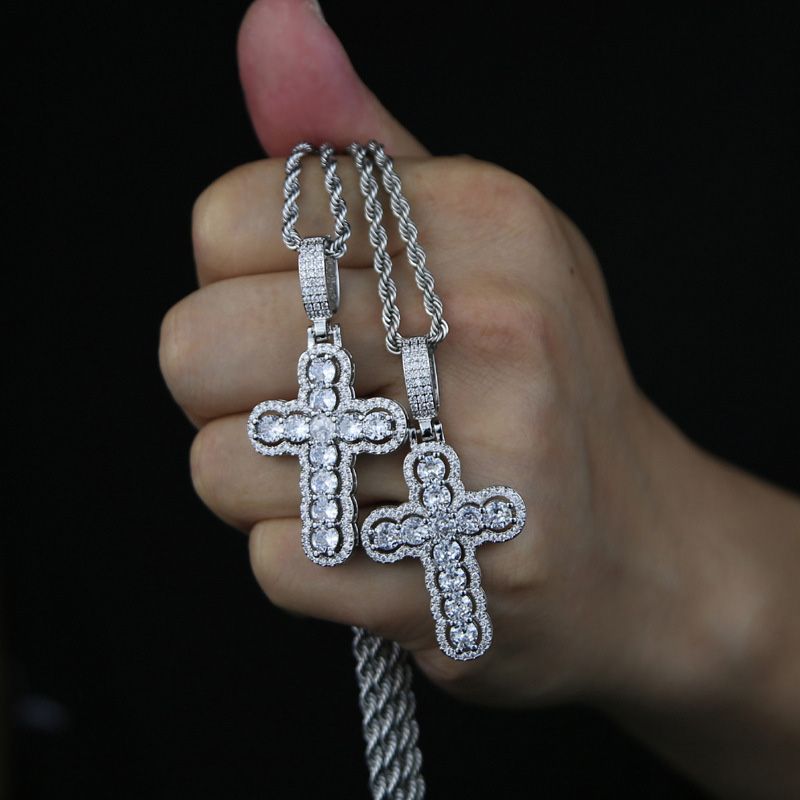 Iced Hollow Round Cut Cross Moissanite Pendant in White Gold